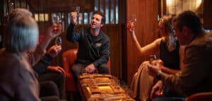 A group of people at a table with whisky glasses, engaged in a whisky tasting at Evolve Spirits Bar.